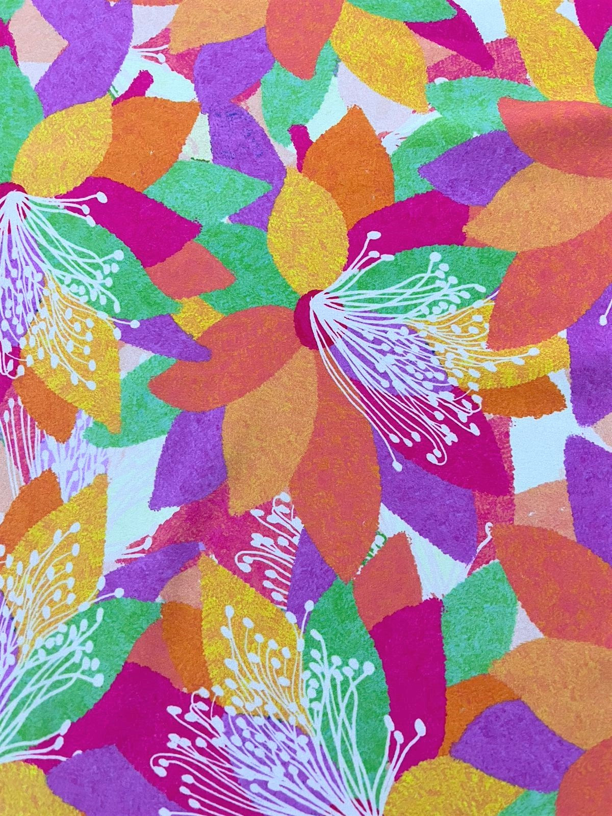 Seda francesa floral fucsia, naranja y lila drapeada, mostrando su brillo y caída fluida