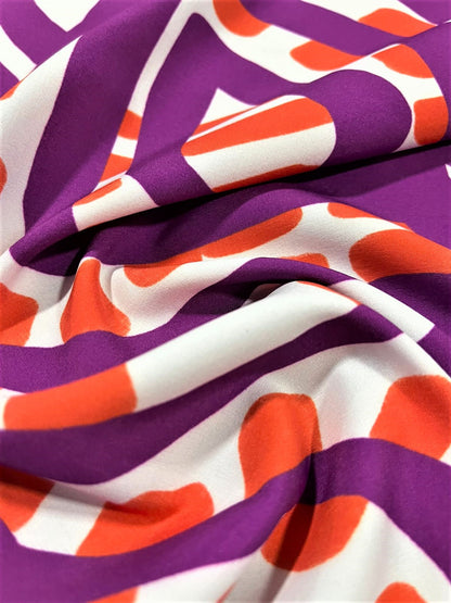 Seda francesa abstracta fucsia oscuro y naranja drapeada, mostrando su brillo y caída fluida